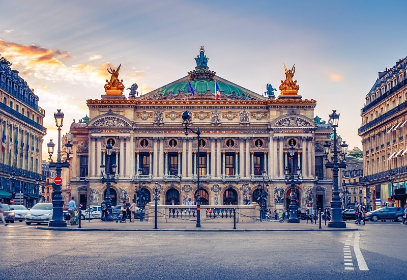 Opera square with Garnier Palace in Paris, France at night with city illuminations