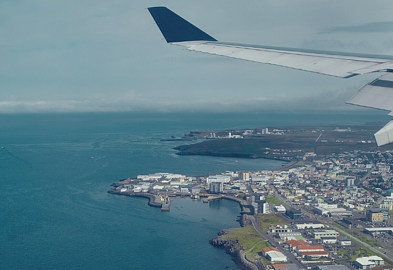 View from airplane window on the sea and coastline in Iceland