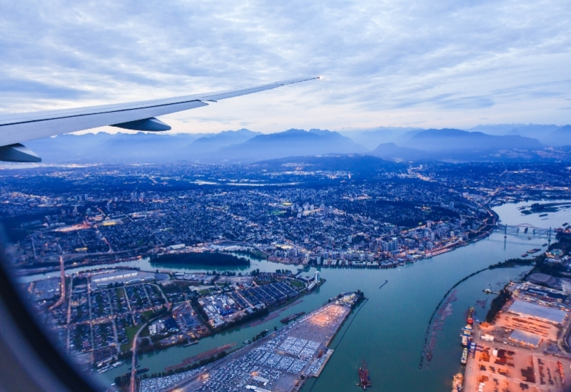 View from airplane window on fields in wing with top view of Vancouver,Canada